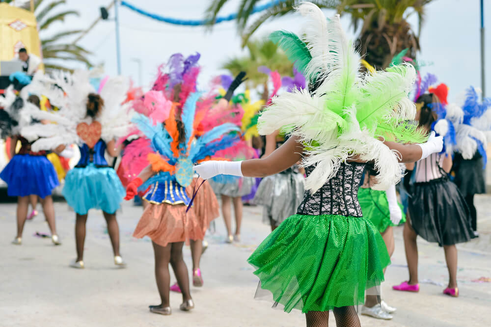 People dancing during a parade during Aruba Carnival season